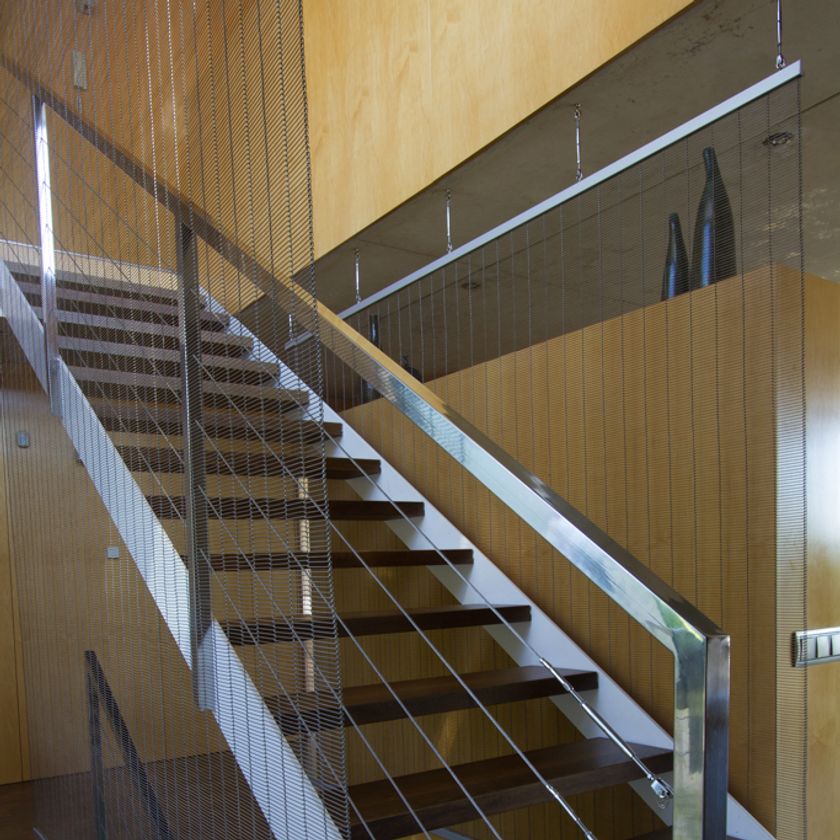 Metal mesh separating corridor from stairs